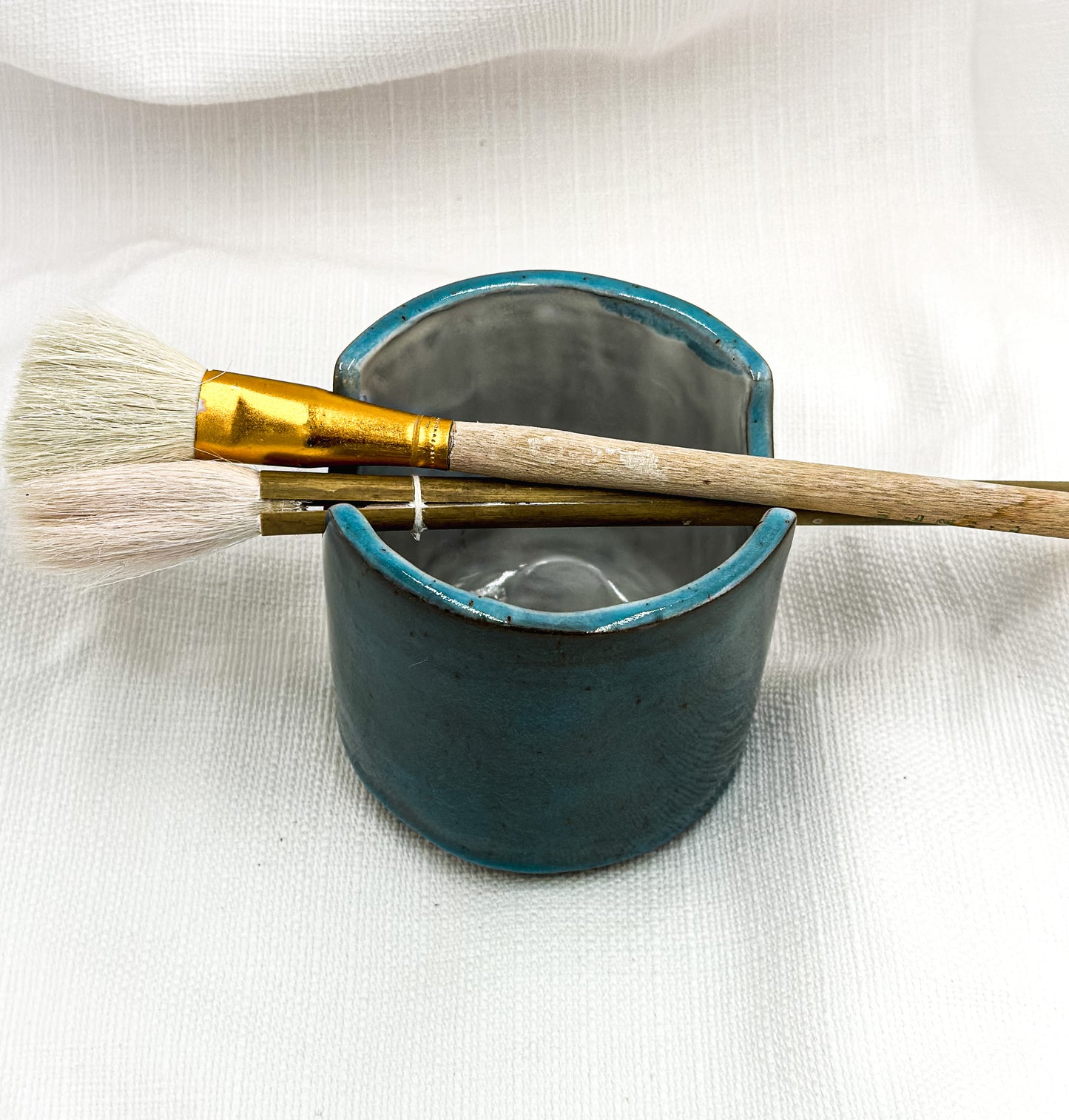 Big dark blue artist’s pot for brushes